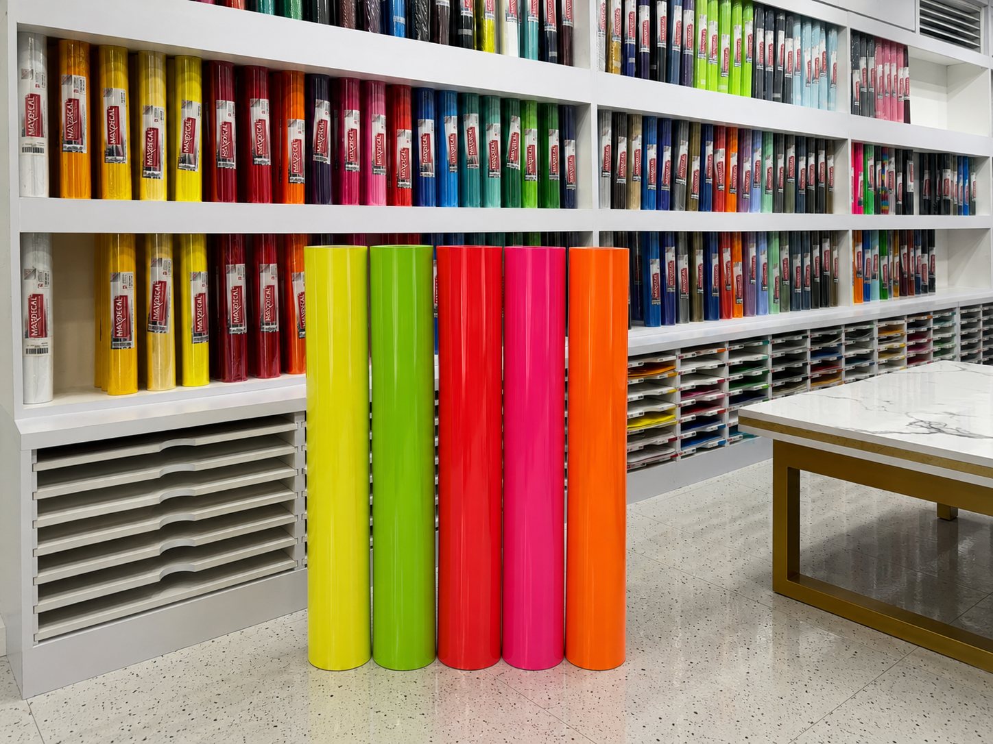 7900 fluorescent rolls in front of the full SKU wall